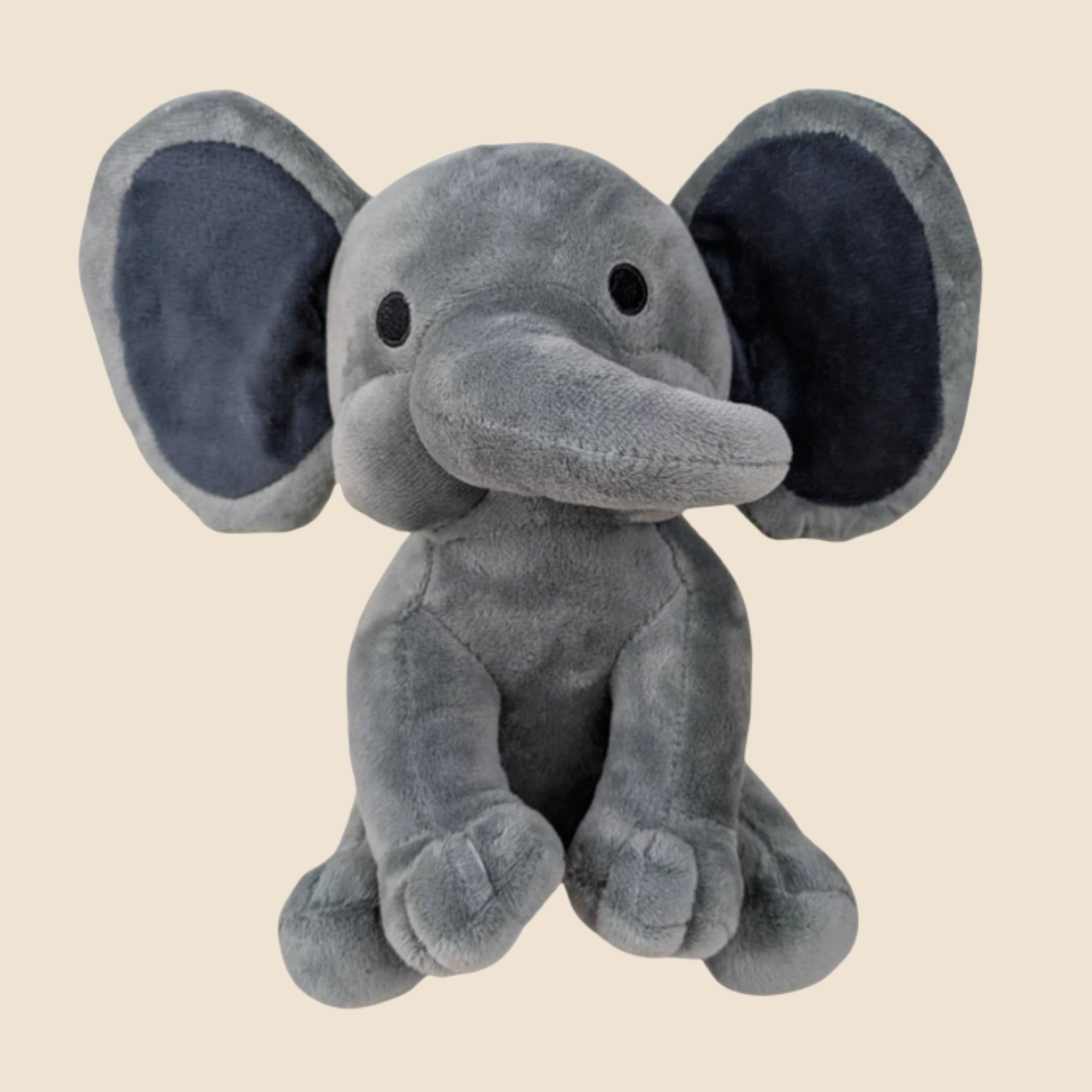 Plush elephant toy on a beige background