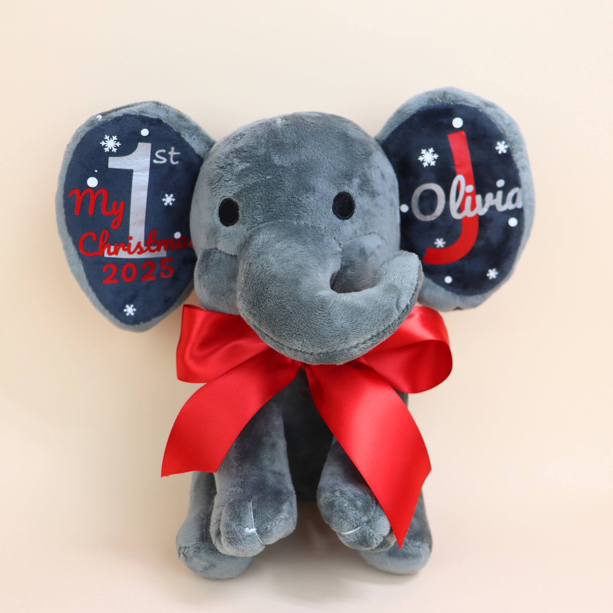 Gray personalized first Christmas elephant plush with red and gray ears and satin bow.